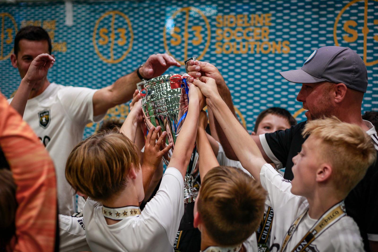 Players celebrate with the S3 Super Cup trophy